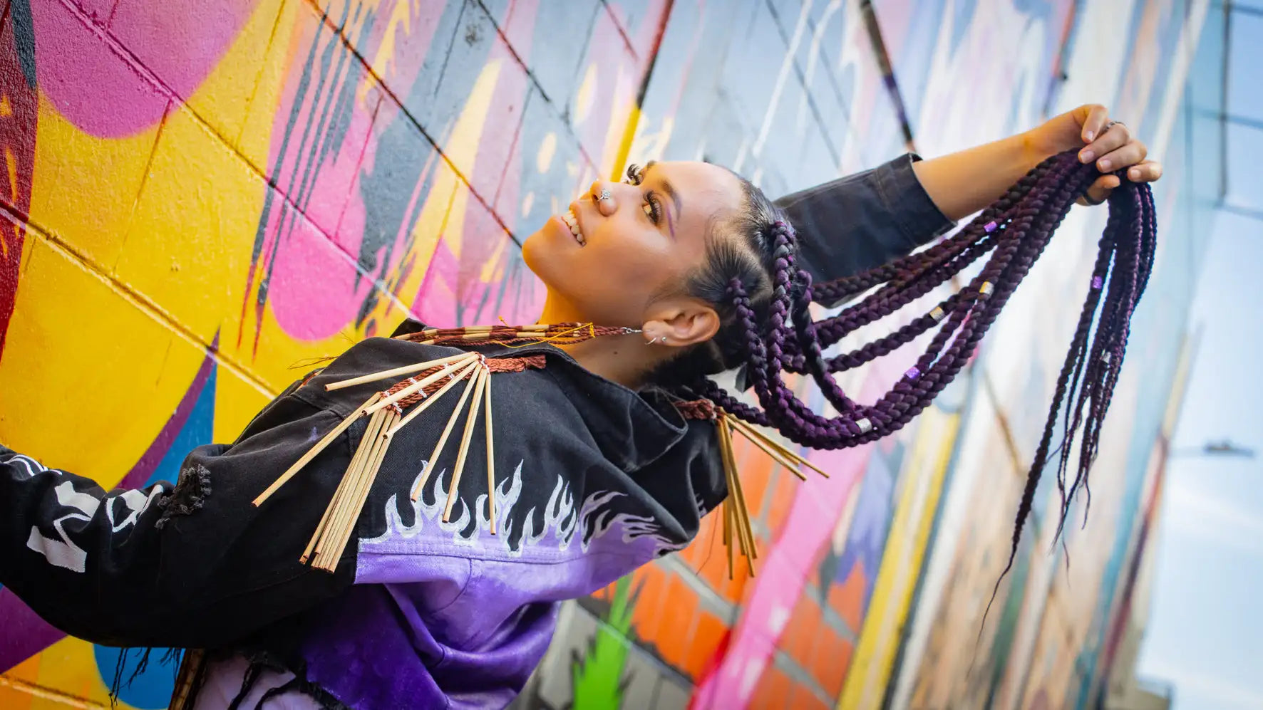 Purple braided hair extension set with metallic accents.